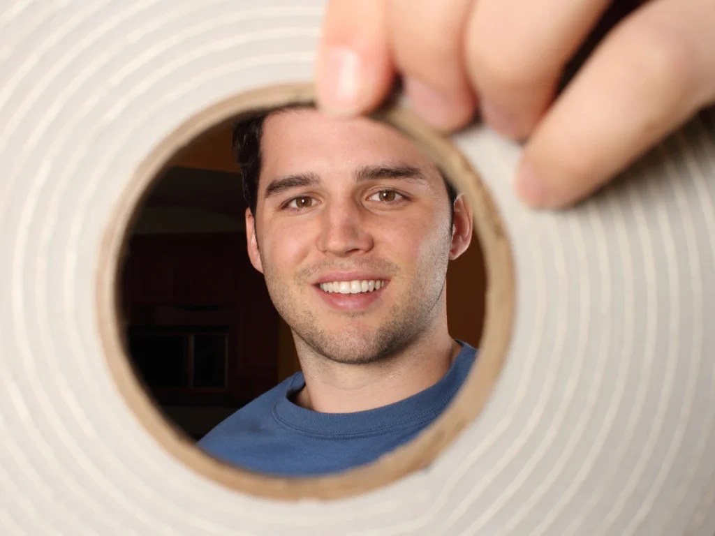 a man holding a garage door weather stripping